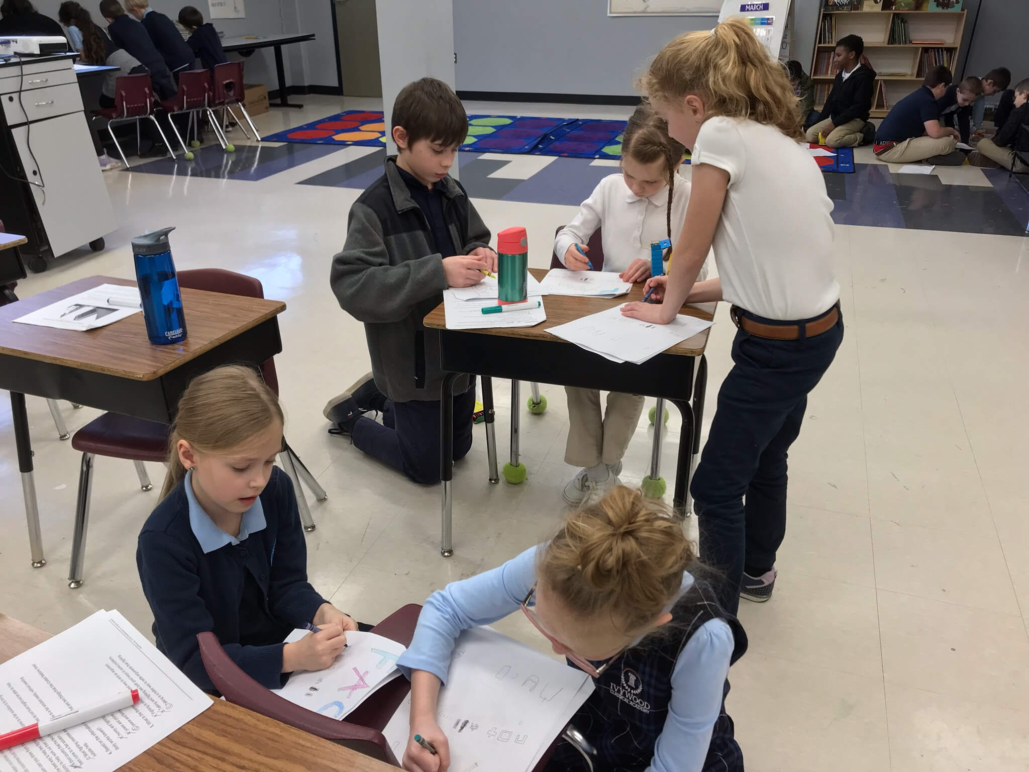 Fifth grade students helped the second grade students color cytoplasm, nuclei, and cell membranes in animal cells and chloroplasts, cell walls, and vacuoles in eukaryotic plant cells with crayons.