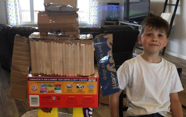 3rd Grade student with Robot made out of recyclables