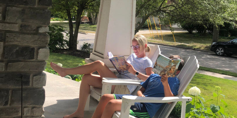 students reading on front porch