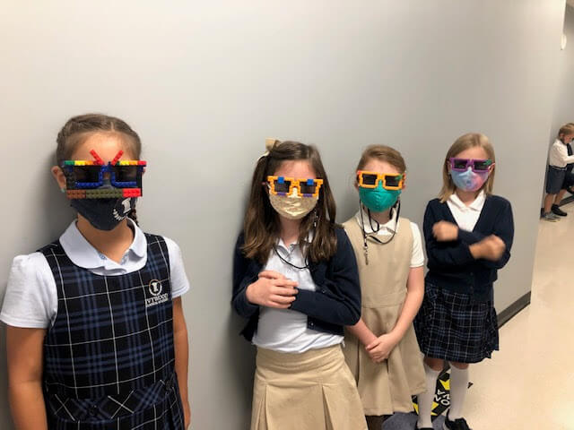 Students wearing sunglasses and masks