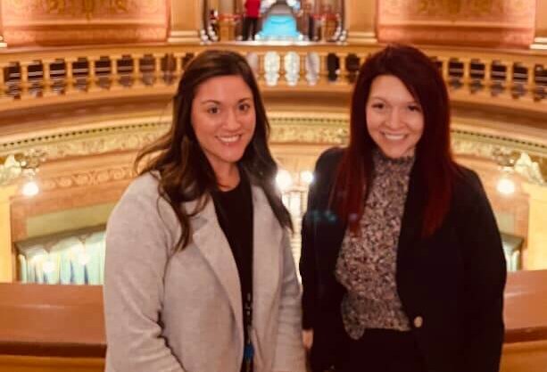 Image of Stephanie Kooiker and Kayla Cruther at the State's Capitol in Lansing, smiling in the foyer for a picture in the Capitol.