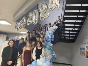 Photo of Ivywood Classical Academy students lined up at the stairs to pose for a picture at the inaugural Homecoming dance